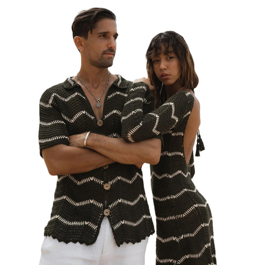 Black and white striped short sleeve shirt on a sandy beach