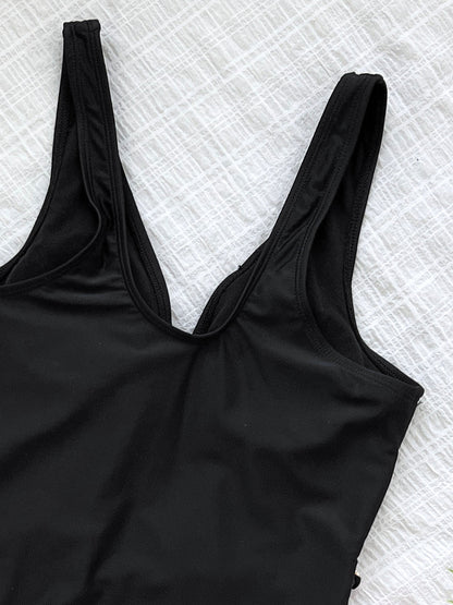 Black one-piece swimsuit with gold chain accents