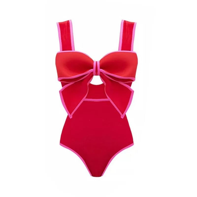 Red skirt with pink oolka dots and red one-piece swimsuit with a large bow detail on the front.