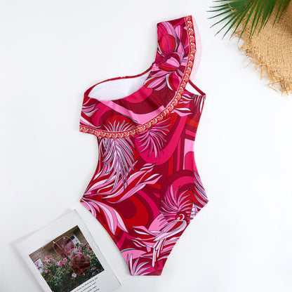Red one-piece swimsuit with a single ruffled shoulder,paired with a matching short skirt