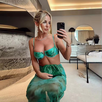 Two piece outfit that appears to be a teal crop top and a maxi skirt with a mermaid-style silhouette and print.