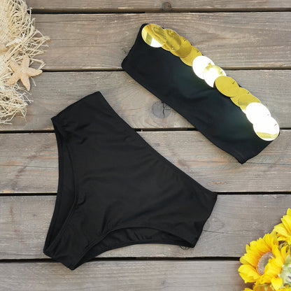 Black bandeau bikini top with a metallic gold stripe and high waisted black bikini bottoms.