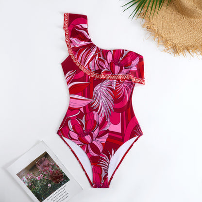 Red one-piece swimsuit with a single ruffled shoulder,paired with a matching short skirt
