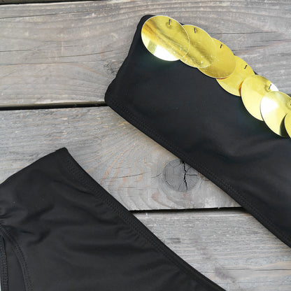 Black bandeau bikini top with a metallic gold stripe and high waisted black bikini bottoms.