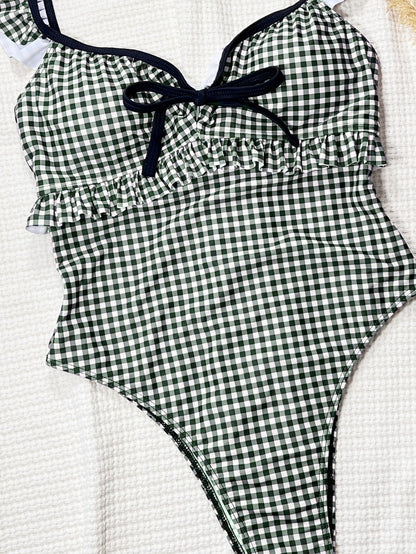 Black and white gingham one-piece swimsuit with ruffled straps.